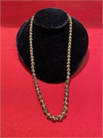 Interesting gold ball necklace. 22 inches in