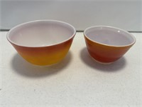 2- Pyrex orange mixing bowls - largest measures 7