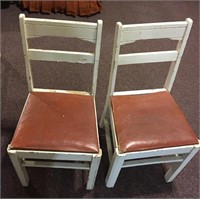 (2) matching primitive chairs