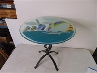 small glass top table with metal base. Sailboats