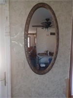 Large gold framed oval mirror