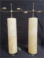 Pair of alabaster cylinder table lamps on glass