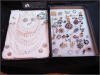 Two containers of costume jewelry, mostly