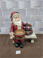 Santa figure sitting on a bench
