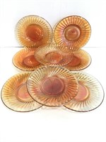 Eight vintage carnival glass saucer plates
