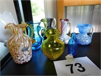 Six small blown glass pitchers: blue, red, amber