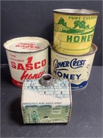 Collection of 4 honey and maple syrup cans.