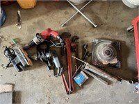 Tools, including pipe wrenches, drills, and