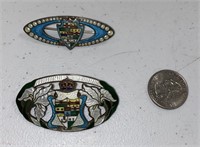 TWO ANTIQUE ENAMEL BROOCHES, ONE MISSING PIN.