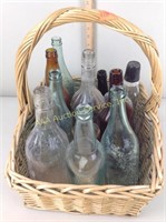 Basket filled with old glass bottles including