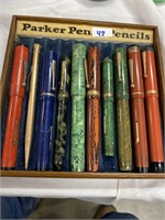 Antique fountain pens and pencils in a wooden pen