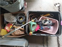 Plastic storage tote of extension cords, weed