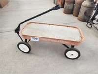 Child's wagon full of concrete used for plant