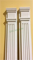 Two matching white plastic architectural columns