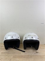 Two white biking helmets