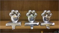 Lot of three metal silver tone stocking holders