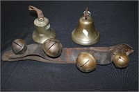 Old sleigh bells and two brass bells one has