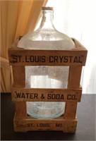 Glass water jug in shipping crate