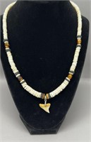 Puka shell necklace with shark tooth pendant