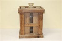 Large vintage glass water bottle in wooden crate