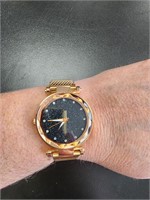 Rose gold color metal watch