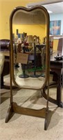 Antique beveled glass vanity mirror on wooden