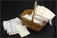 Quantity of vintage European linen in a canebasket