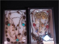 Two containers of fashion jewelry including