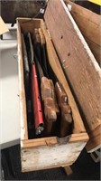 Wood box full of  all types of hand saws