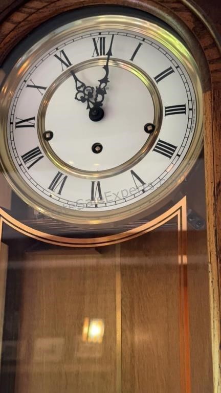 HOWARD MILLER WALL CLOCK  Oak stained wood with