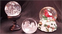 Two snow globes: one is musical with cardinal