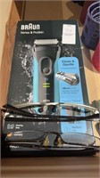 Two pairs of reading glasses and braun series 3