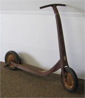 Vintage metal scooter with hard tires. Note: