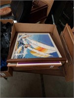 Box of art needlepoint and posters