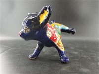 Hand painted figurine of a bull dog relieving hims