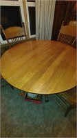 pedestal table with 4 chairs and 2 leaves