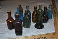 11 minature apothecare bottles