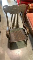 Antique child’s rocking chair with a pressed