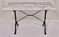Marble top yard table, cast iron base, 47" x 23.5"