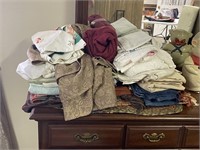 stack of linens table cloths, placemats,