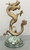 Brass dragon sculpture on green stone base