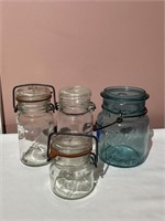4 Assorted Glass Jars With Lids