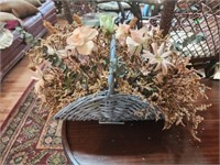 Faux floral arrangement in blue basket