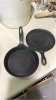 Two shallow cast iron frying pans, both 9 1/2