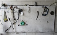 Contents of wall includes hand saws, circular saw