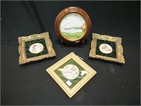Four framed plaques: three are of people in