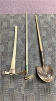 Lot of garden tools: pick, hoe and shovel.