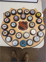 NHL HOCKEY pucks on plaque 23in. X23in.