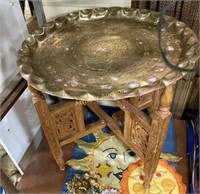 BRASS TABLE WITH CARVED WOODEN BASE
