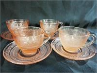 Pink pressed glass cups and saucers